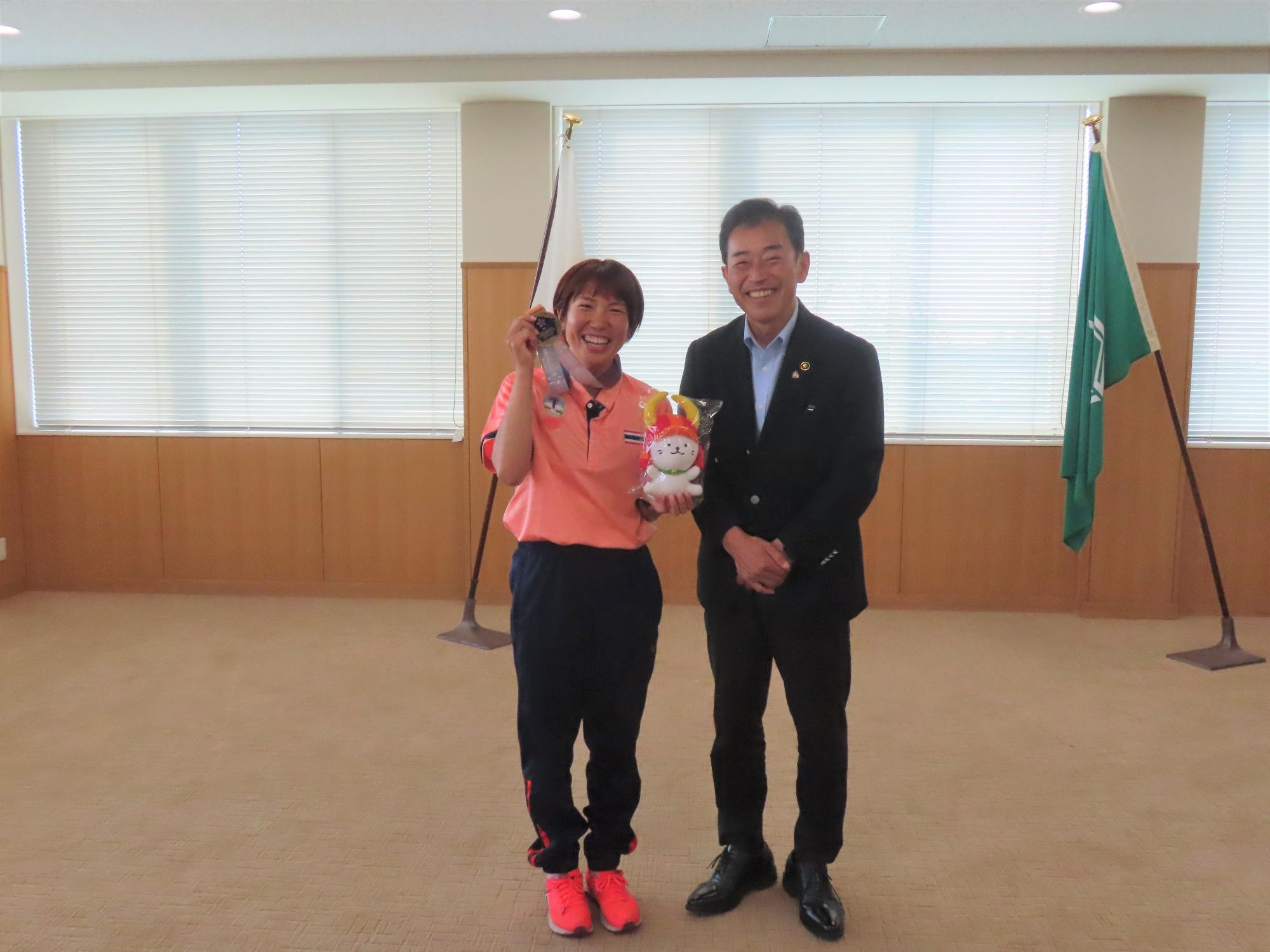 ひこにゃんのぬいぐるみを持った槇森さんと市長のツーショット