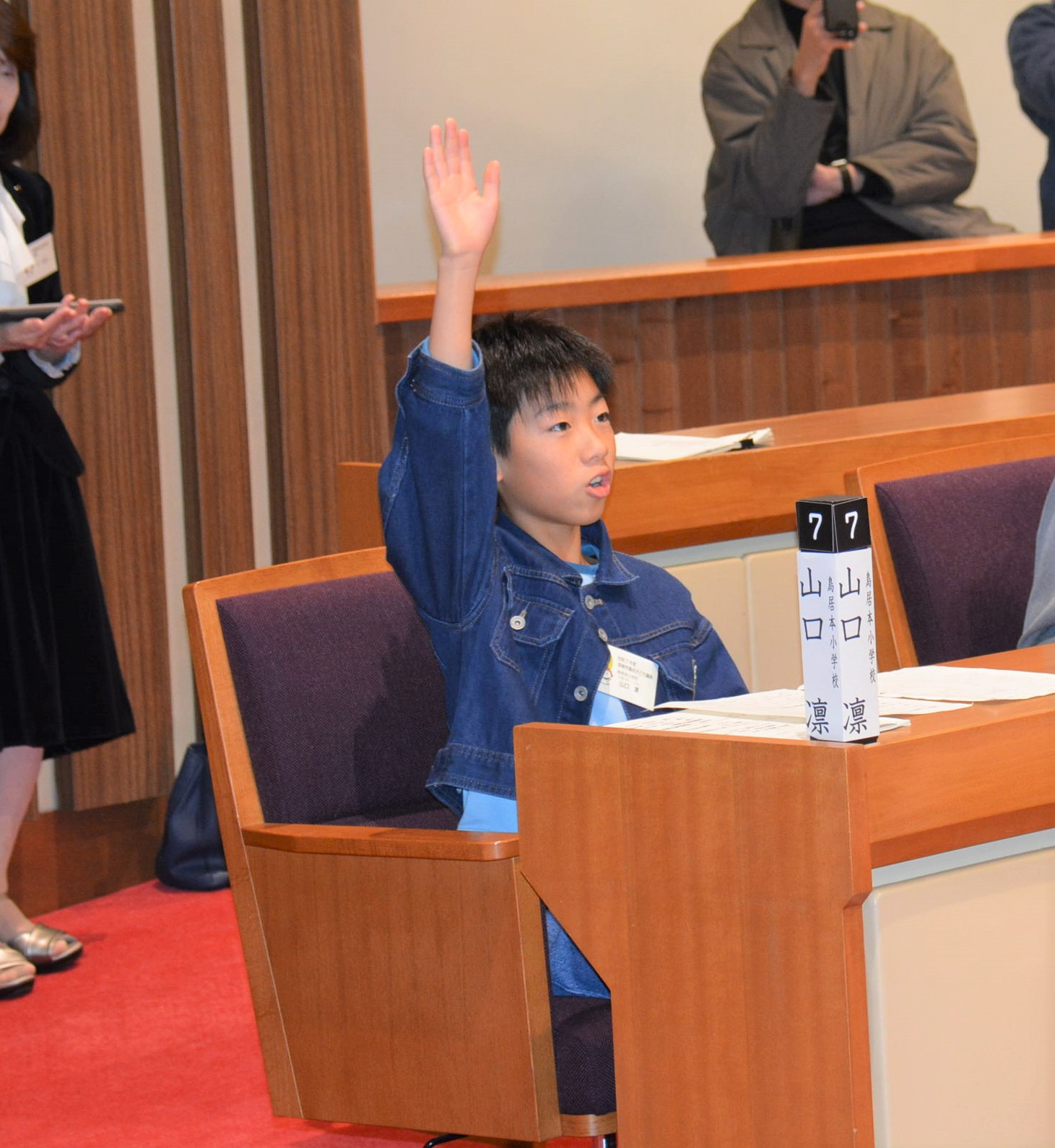 席に座り挙手をする子どもの様子の画像