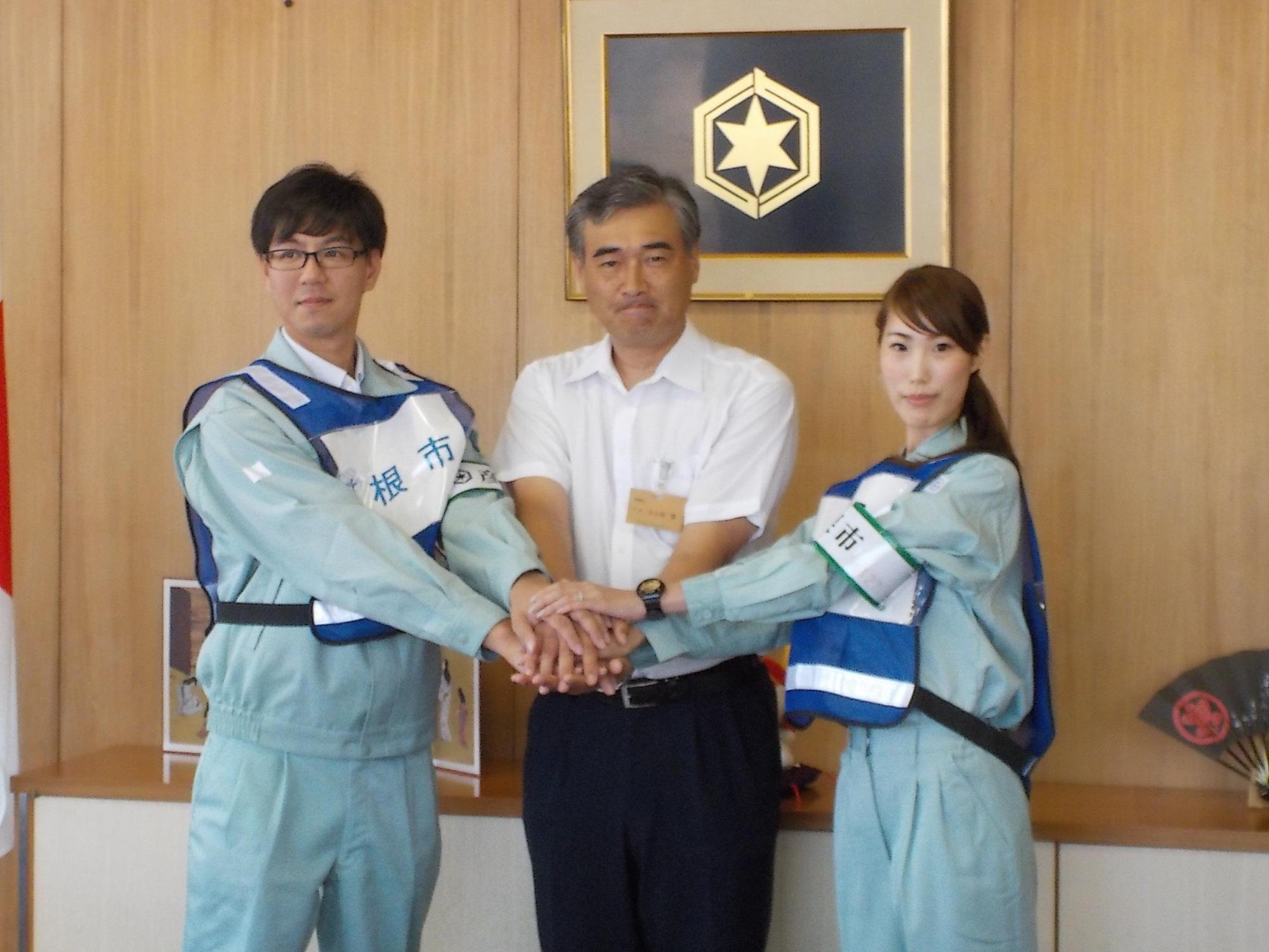 熊本に派遣される2名の職員と握手を交わす市長の写真