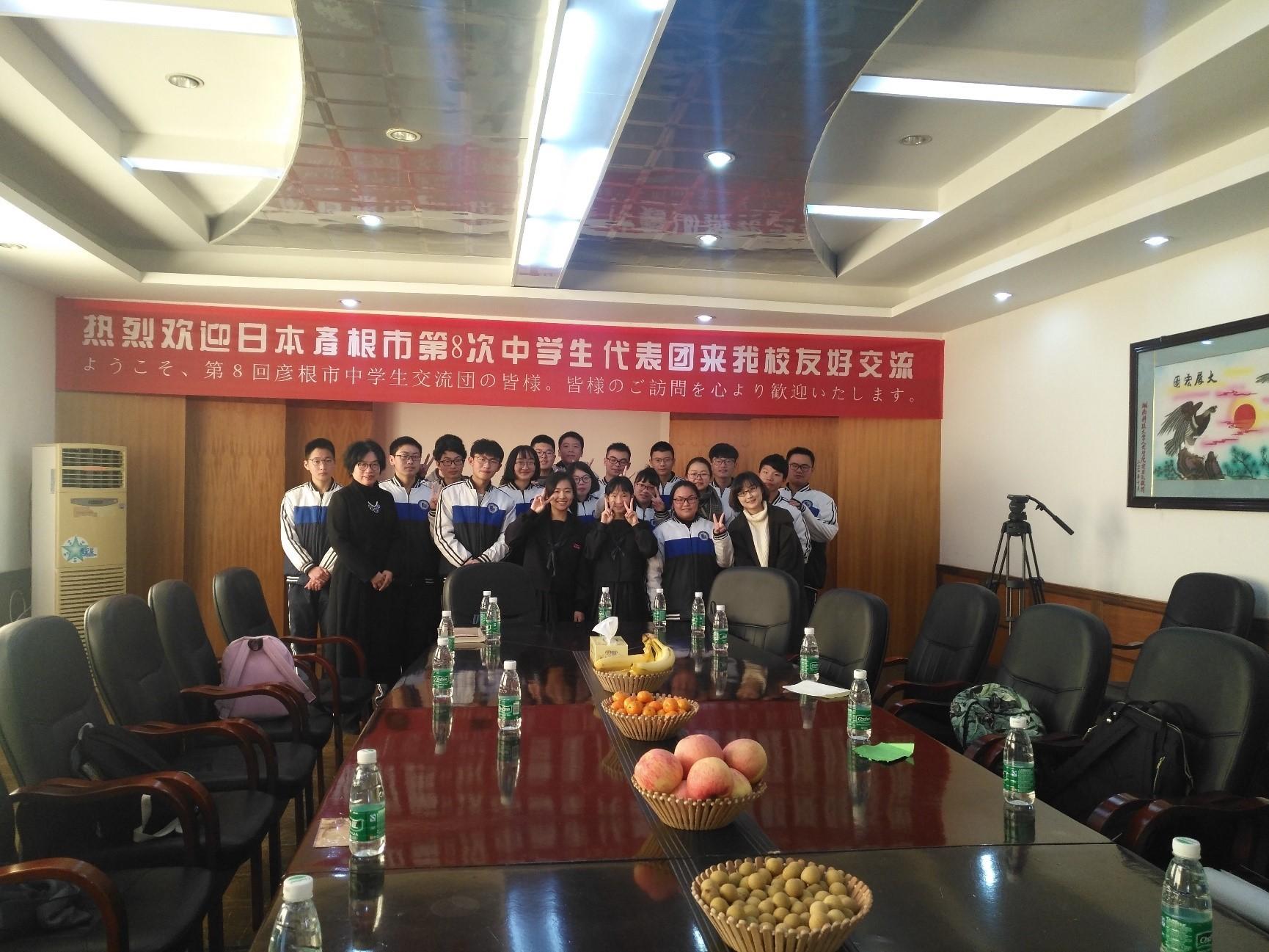 本市の派遣団が中華人民共和国湖南省湘潭市を訪問して湘潭市の中学生との交流会で記念撮影をしている写真